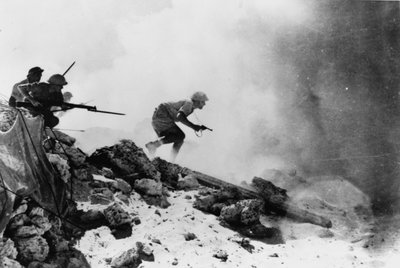 A British officer armed with a revolver leading his men forward with fixed bayonets, one of seven official photographs relating to the 2nd Battle of El Alamein, 1942 by English Photographer